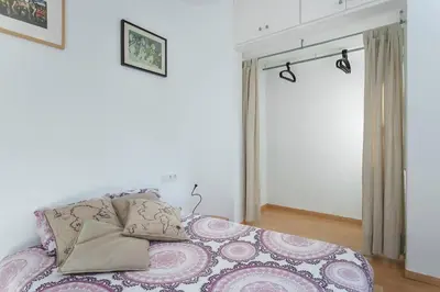 a bedroom with a bed with a purple blanket at ApartEasy - Lightly, central and quiet apartment in Barcelona