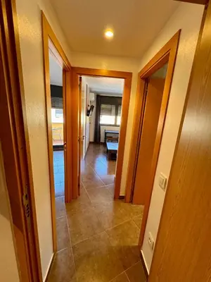 a white bed in a room with a bathroom at MT Boutique Suites y Apartamentos - Adults Only - in Mataró