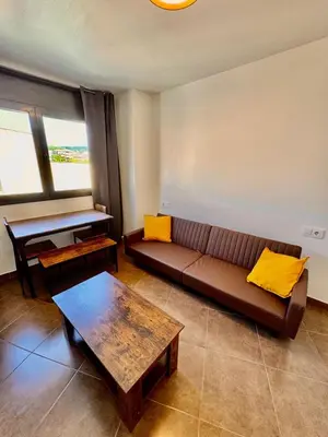 a bedroom with a white bed with a tv on the wall at MT Boutique Suites y Apartamentos - Adults Only - in Mataró