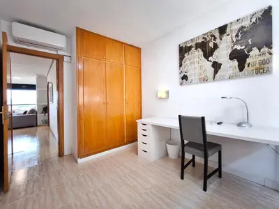 a white desk with a black chair in a room at Duplex con piscina en Rubí in Rubí