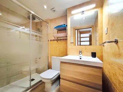 a bathroom with a toilet and a sink and a shower at Duplex con piscina en Rubí in Rubí