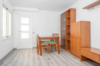 a dining room table with a chair and a desk at HomeHolidaysRentals Deva - Costa Barcelona in Pineda de Mar