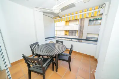a room with a table and chairs on a balcony at HomeHolidaysRentals Deva - Costa Barcelona in Pineda de Mar