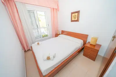 a small bedroom with a bed and a window at HomeHolidaysRentals Ancora - Costa Barcelona in San Pol de Mar