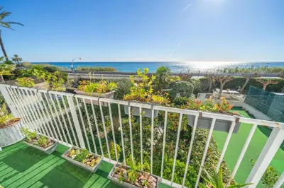 a balcony with plants and the ocean in the background at HomeHolidaysRentals Ancora - Costa Barcelona in San Pol de Mar