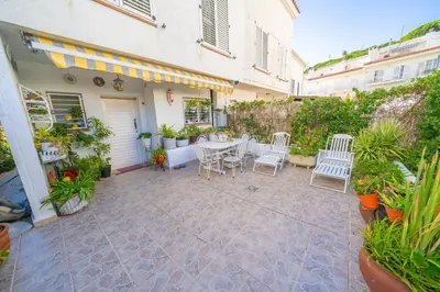 a patio with a table and chairs and plants at HomeHolidaysRentals Ancora - Costa Barcelona in San Pol de Mar