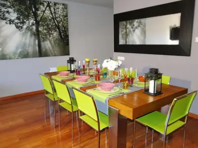 a dining room with a table with green chairs at Villa Sitges El Olivo High Comodity AC Pool Heated 30º Optional Real Garden Pool XXL 10 min drive from Sitges in Olivella