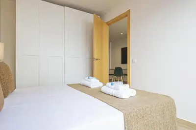 a bedroom with a bed with towels on it at Alcam Galileu in Barcelona