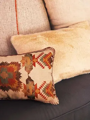 a pillow sitting on a couch with a patterned pillow at Charming Parallel in Barcelona