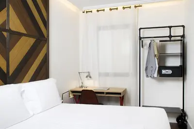 a bedroom with a bed and a desk and a desk at Praktik Vinoteca in Barcelona
