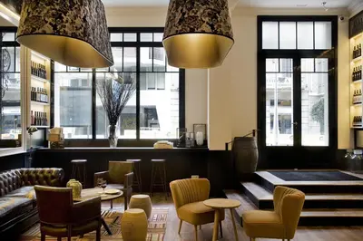 a restaurant with chairs and a table and some windows at Praktik Vinoteca in Barcelona