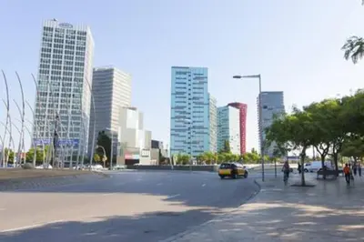 a parking lot with a yellow car in a city at Designer Apt near FIRA Balcony 5PPWIFISMART TV by MyRentalHost in Hospitalet de Llobregat