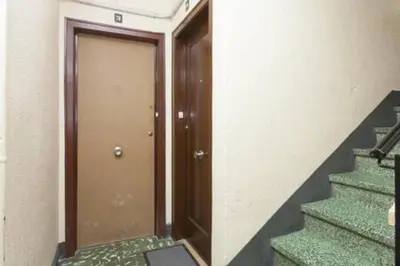 a hallway with a door and stairs in a building at Designer Apt near FIRA Balcony 5PPWIFISMART TV by MyRentalHost in Hospitalet de Llobregat