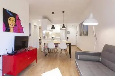a living room with a couch and a table with chairs at Designer Apt near FIRA Balcony 5PPWIFISMART TV by MyRentalHost in Hospitalet de Llobregat