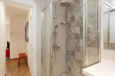 a bathroom with a shower with a glass door at Designer Apt near FIRA Balcony 5PPWIFISMART TV by MyRentalHost in Hospitalet de Llobregat