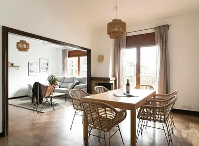 a living room with a table and chairs and a couch at Great Eixample Apartment in Barcelona
