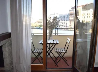 a table and chairs on a balcony with a view at Great Eixample Apartment in Barcelona