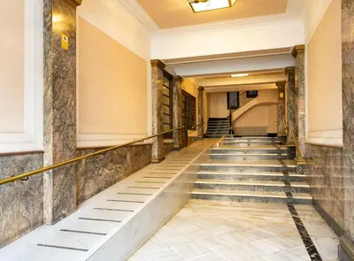 a long staircase in a building with stone walls at Great Eixample Apartment in Barcelona