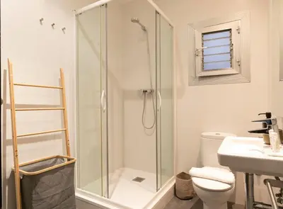 a bathroom with a shower and a toilet and a sink at Great Eixample Apartment in Barcelona