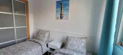 a small bedroom with a bed and a chair at Magnífica Isla de la playa Fórum y CCIB in Sant Adria de Besos