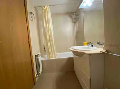 a bathroom with a sink and a bath tub at Big Family Terrassa Parking and noise free in Terrassa