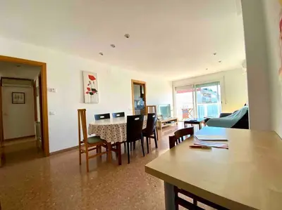 a living room with a table and chairs at Big Family Terrassa Parking and noise free in Terrassa