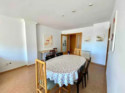 a dining room with a table and chairs and a room with a table at Big Family Terrassa Parking and noise free in Terrassa
