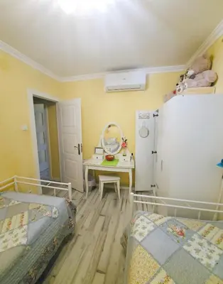 a room with two beds and a table and a refrigerator at Sweet home in Sant Adria de Besos
