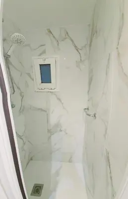 a bathroom with a shower with white marble at Sweet home in Sant Adria de Besos