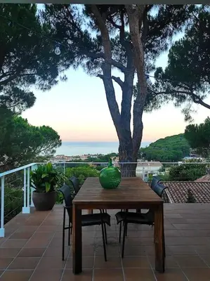 a wooden table with a green bowl on it on a patio at Casa Can Bellavista Barcelona town house in Premia de Dalt