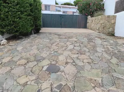 a stone patio with a fence and a hedge at Casa Can Bellavista Barcelona town house in Premia de Dalt