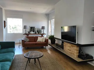 a living room with a couch and a flat screen tv at Casa Can Bellavista Barcelona town house in Premia de Dalt