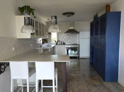 a kitchen with a large counter and white appliances at Casa Can Bellavista Barcelona town house in Premia de Dalt