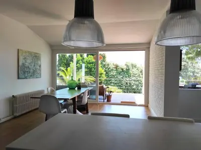 a dining room with two pendant lights and a table at Casa Can Bellavista Barcelona town house in Premia de Dalt