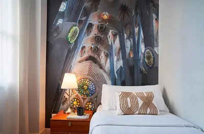 a bedroom with a bed with a painting on the wall at Catalan Comfort near Sagrada Familia by MyRentalHost in Barcelona