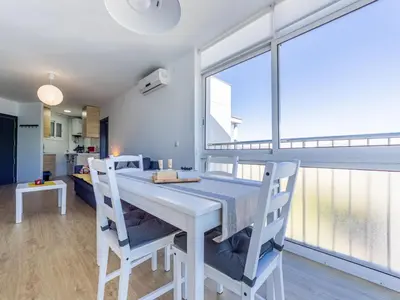 a dining room with a white table and two chairs at Apartment Zafiro by Interhome in Cubelles