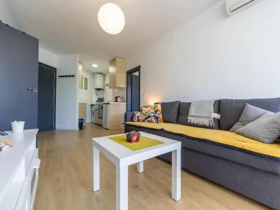 a living room with a couch and a table at Apartment Zafiro by Interhome in Cubelles