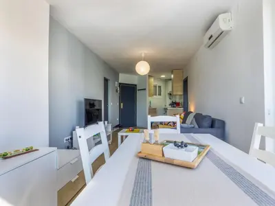 a kitchen and living room with a table and chairs at Apartment Zafiro by Interhome in Cubelles
