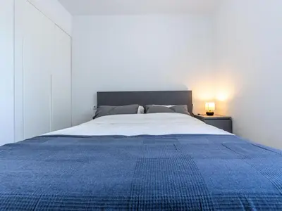 a bedroom with a blue bed with a blue blanket at Apartment Zafiro by Interhome in Cubelles
