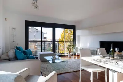 a living room with a couch and a table at Apartment close to Diagonal Beach in Barcelona