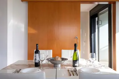 a table with two bottles of wine and two glasses at Apartment close to Diagonal Beach in Barcelona