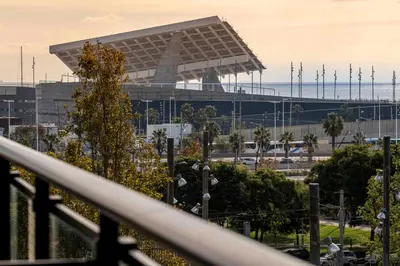 a view of a stadium with a building in the background at Apartment close to Diagonal Beach in Barcelona