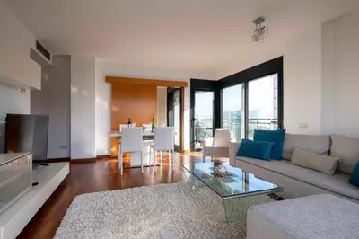 a living room with a couch and a table at Apartment close to Diagonal Beach in Barcelona