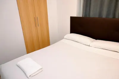 a bedroom with a bed with two pillows on it at Homenfun Barcelona Guinardó Hospital Sant Pau in Barcelona