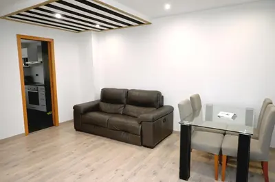 a living room with a couch and a table at Homenfun Barcelona Guinardó Hospital Sant Pau in Barcelona
