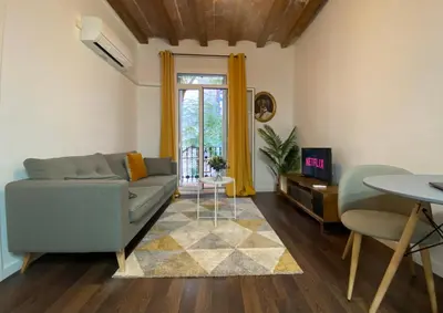 a living room with a couch and a table at Cosy Urban Oasis 1BD in Poble Sec By MyRentalHost in Barcelona