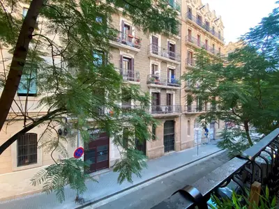 an empty street in front of a large building at Cosy Urban Oasis 1BD in Poble Sec By MyRentalHost in Barcelona