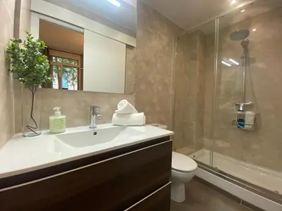 a bathroom with a sink and a toilet and a shower at Cosy Urban Oasis 1BD in Poble Sec By MyRentalHost in Barcelona
