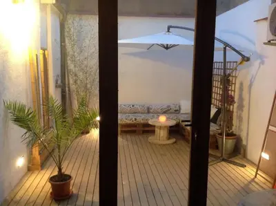 a view of a living room with a couch and a table at Roós, design loft near the sea. in Barcelona