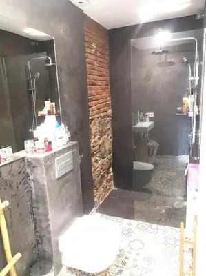 a bathroom with a sink and a toilet and a mirror at Roós, design loft near the sea. in Barcelona
